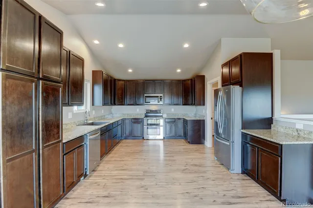 a large kitchen with stainless steel appliances kitchen island granite countertop a large counter top stainless steel appliances and cabinets