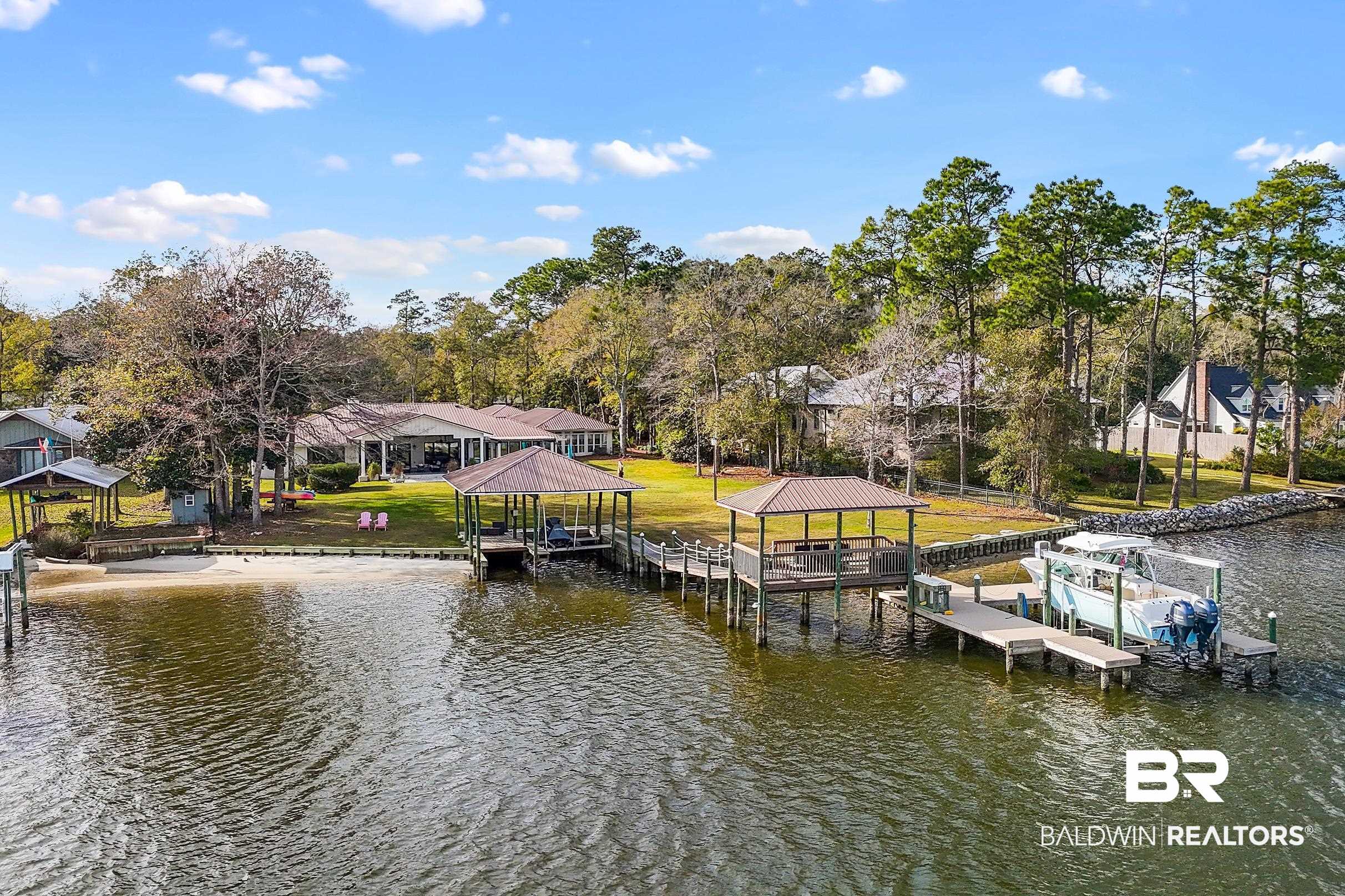 8490 Bay View Drive Foley, AL 36535 - Photo 6 of 67 Dock area with boat lift, a water view, a residential view, and view of scattered trees