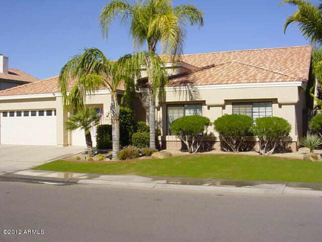5926 East Grandview Road Scottsdale, AZ 85254 - Photo 1 of 18 a view of a house with a yard and potted plants