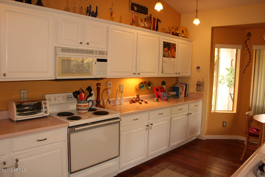 5926 East Grandview Road Scottsdale, AZ 85254 - Photo 13 of 18 a kitchen with stainless steel appliances granite countertop a sink stove and cabinets