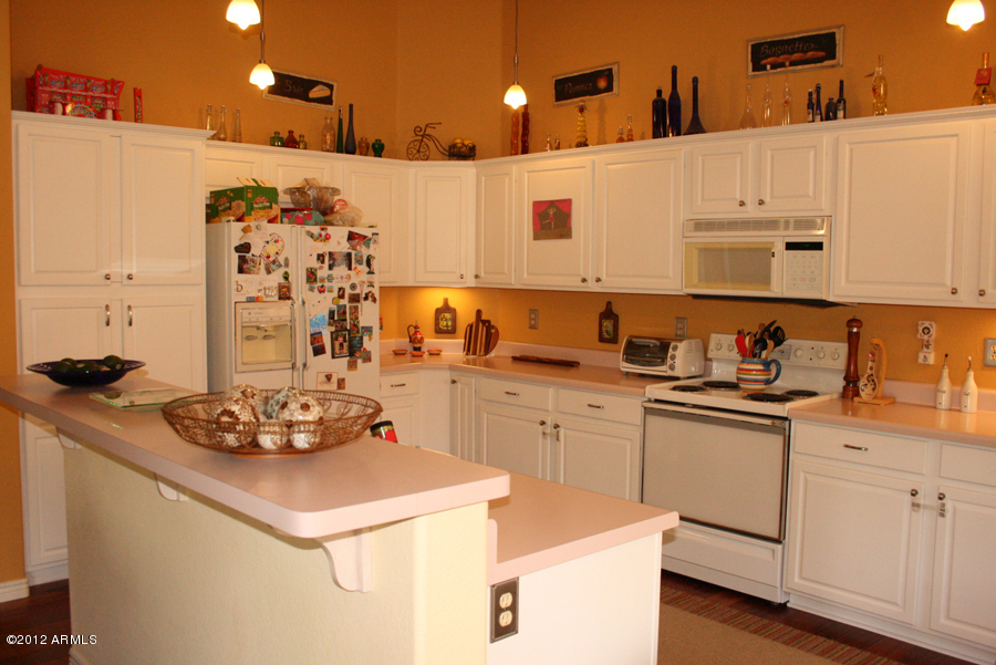 5926 East Grandview Road Scottsdale, AZ 85254 - Photo 15 of 18 a kitchen with stainless steel appliances a sink a stove a refrigerator and white cabinets