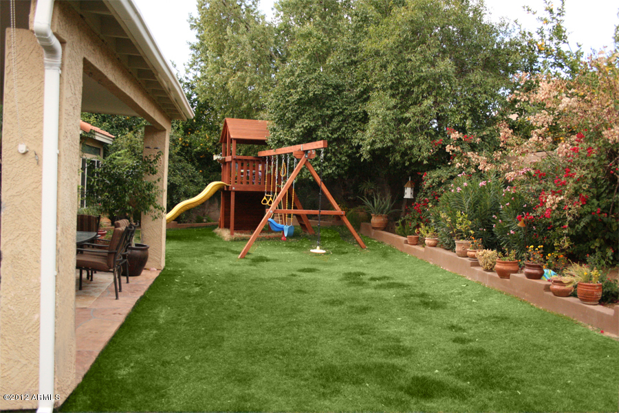 5926 East Grandview Road Scottsdale, AZ 85254 - Photo 17 of 18 a view of a backyard with a slide and a wooden fence