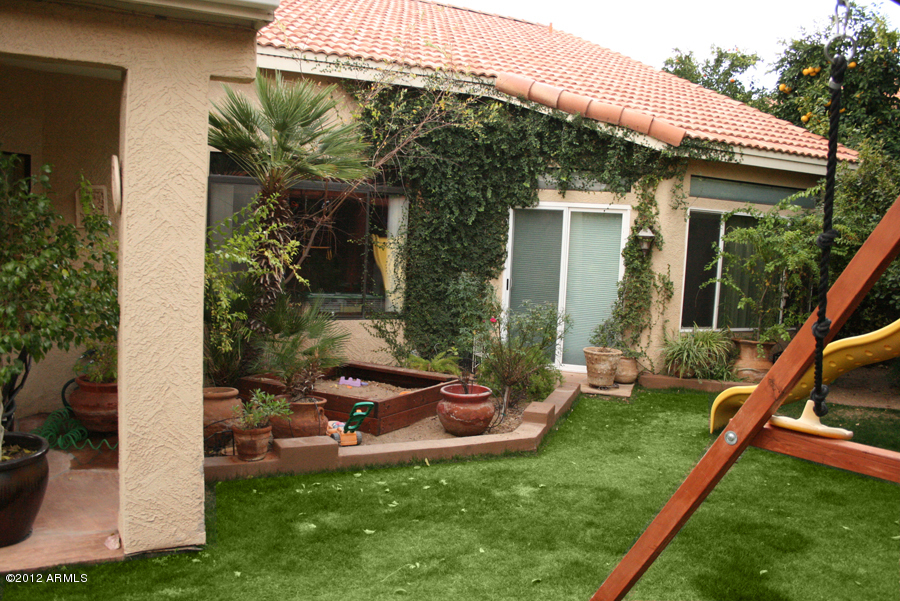 5926 East Grandview Road Scottsdale, AZ 85254 - Photo 18 of 18 a view of a house with backyard sitting area and garden