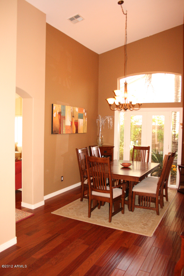 5926 East Grandview Road Scottsdale, AZ 85254 - Photo 8 of 18 a dining room with furniture a chandelier and wooden floor