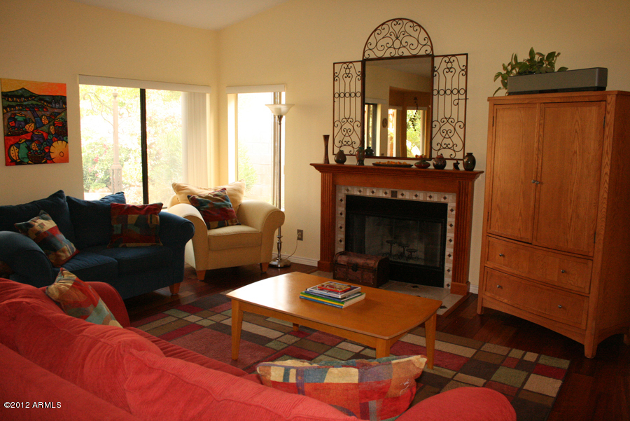 5926 East Grandview Road Scottsdale, AZ 85254 - Photo 10 of 18 a living room with furniture a window and a fireplace
