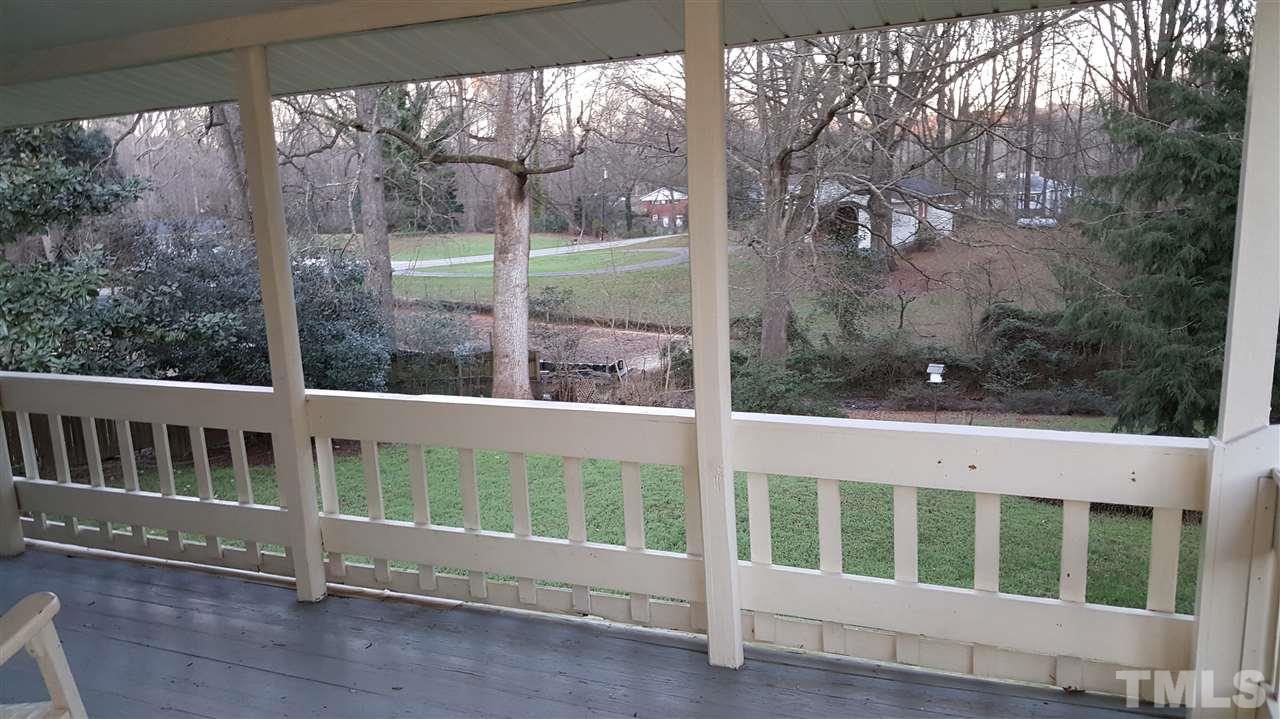 5105 Clearview Street Raleigh, NC 27603 - Photo 5 of 5 a porch with a bench in front of glass door