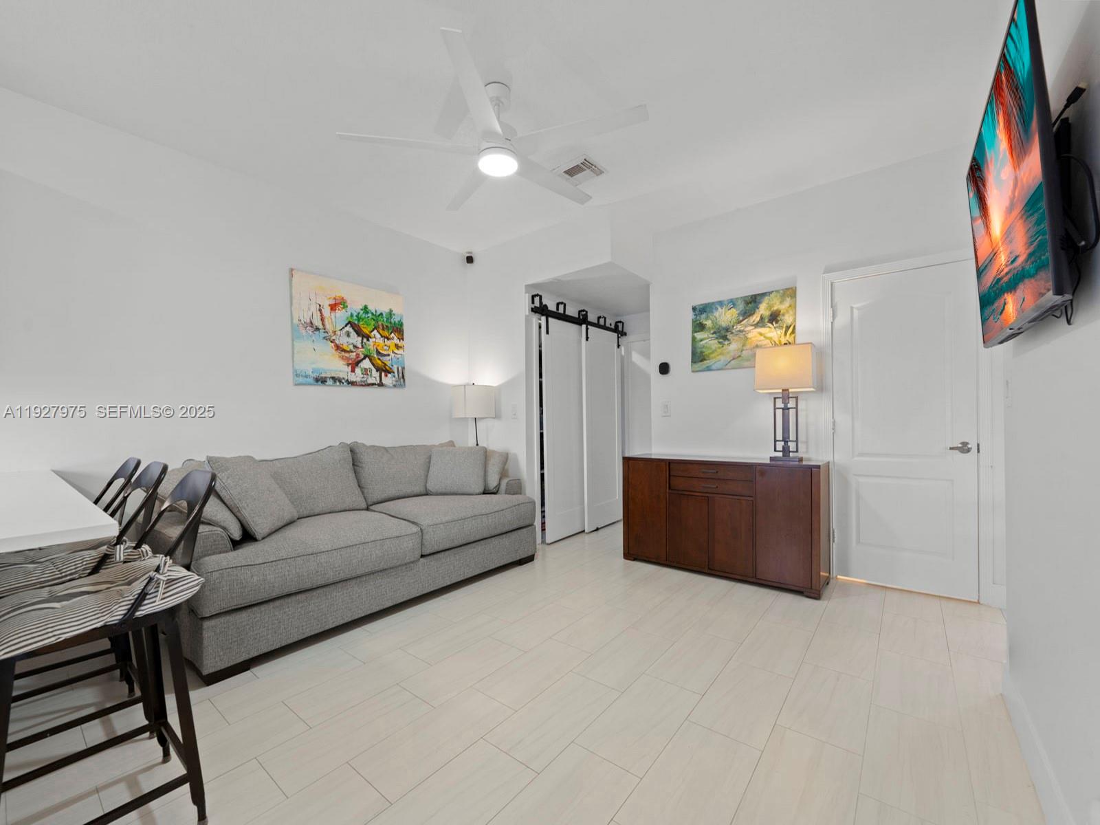 12881 Southwest 49th Court, Unit 12881 Miramar, FL 33027 - Photo 16 of 47 a living room with furniture and painting on the wall
