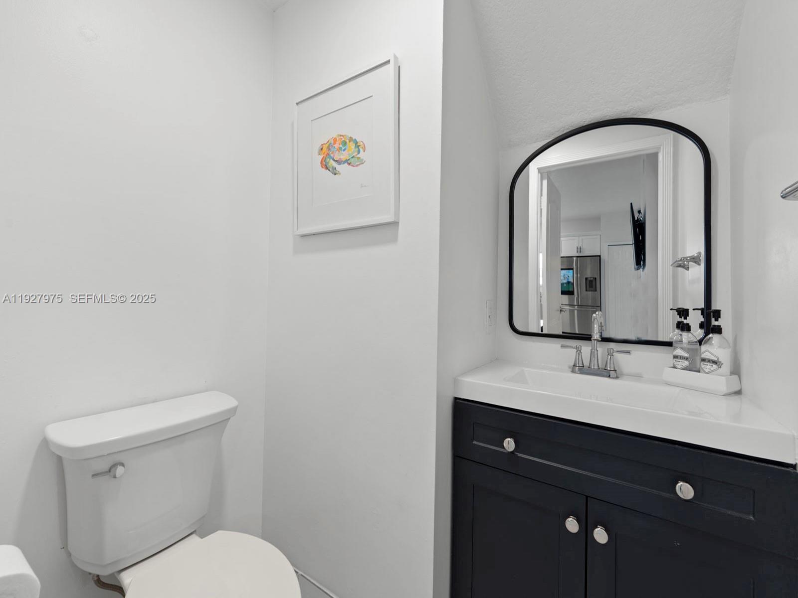 12881 Southwest 49th Court, Unit 12881 Miramar, FL 33027 - Photo 17 of 47 a bathroom with a toilet sink and mirror