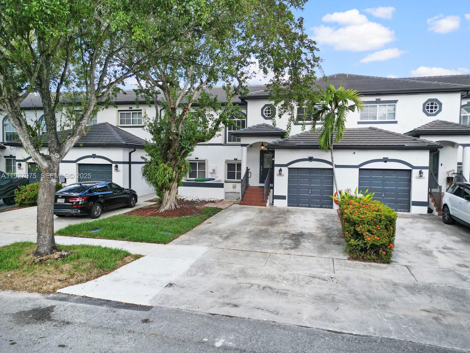 12881 Southwest 49th Court, Unit 12881 Miramar, FL 33027 - Photo 2 of 47 a front view of a house with garden