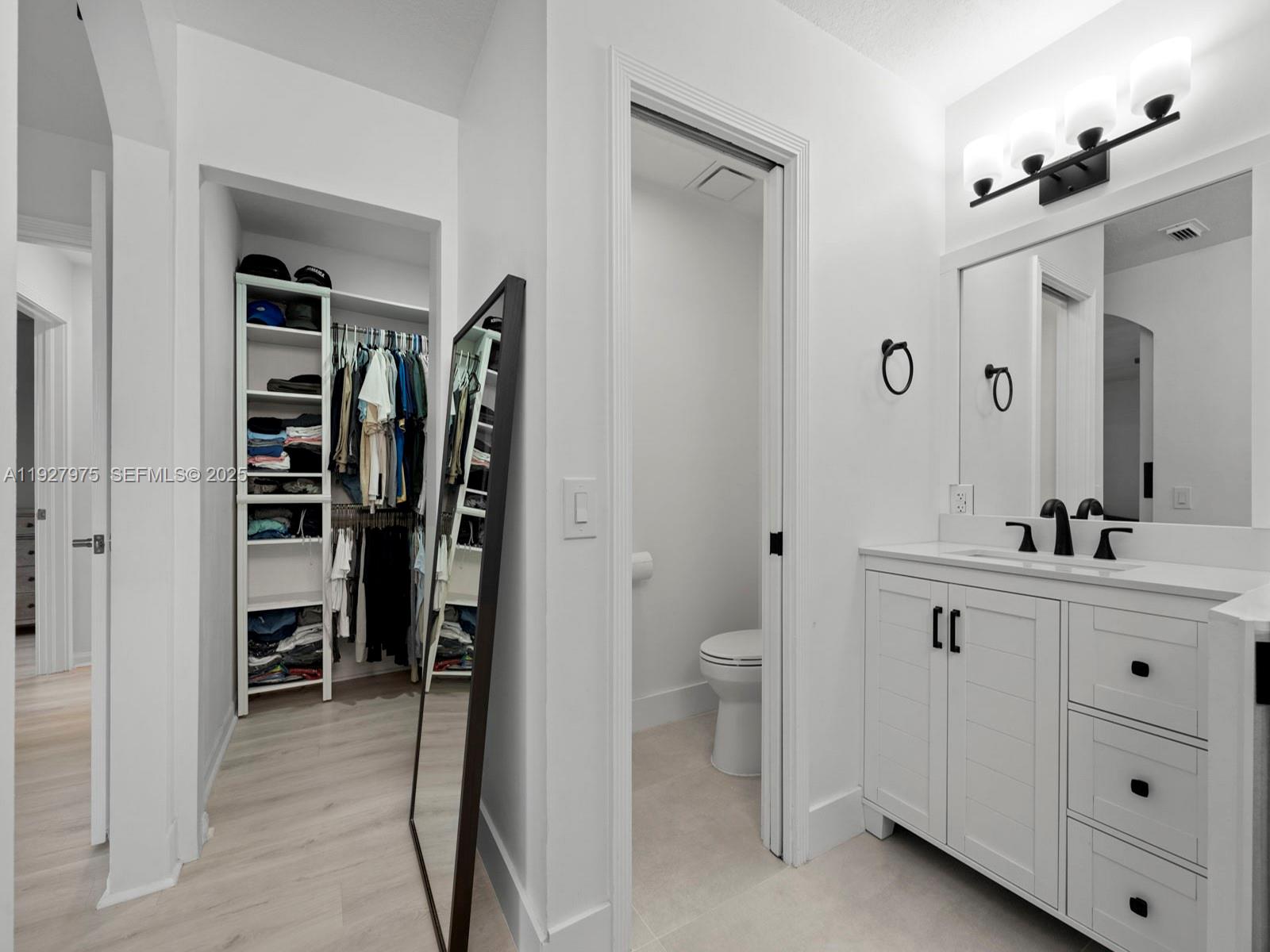 12881 Southwest 49th Court, Unit 12881 Miramar, FL 33027 - Photo 24 of 47 a bathroom with a double vanity sink a toilet and a mirror