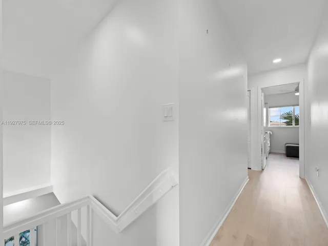 a view of a hallway with wooden shelves