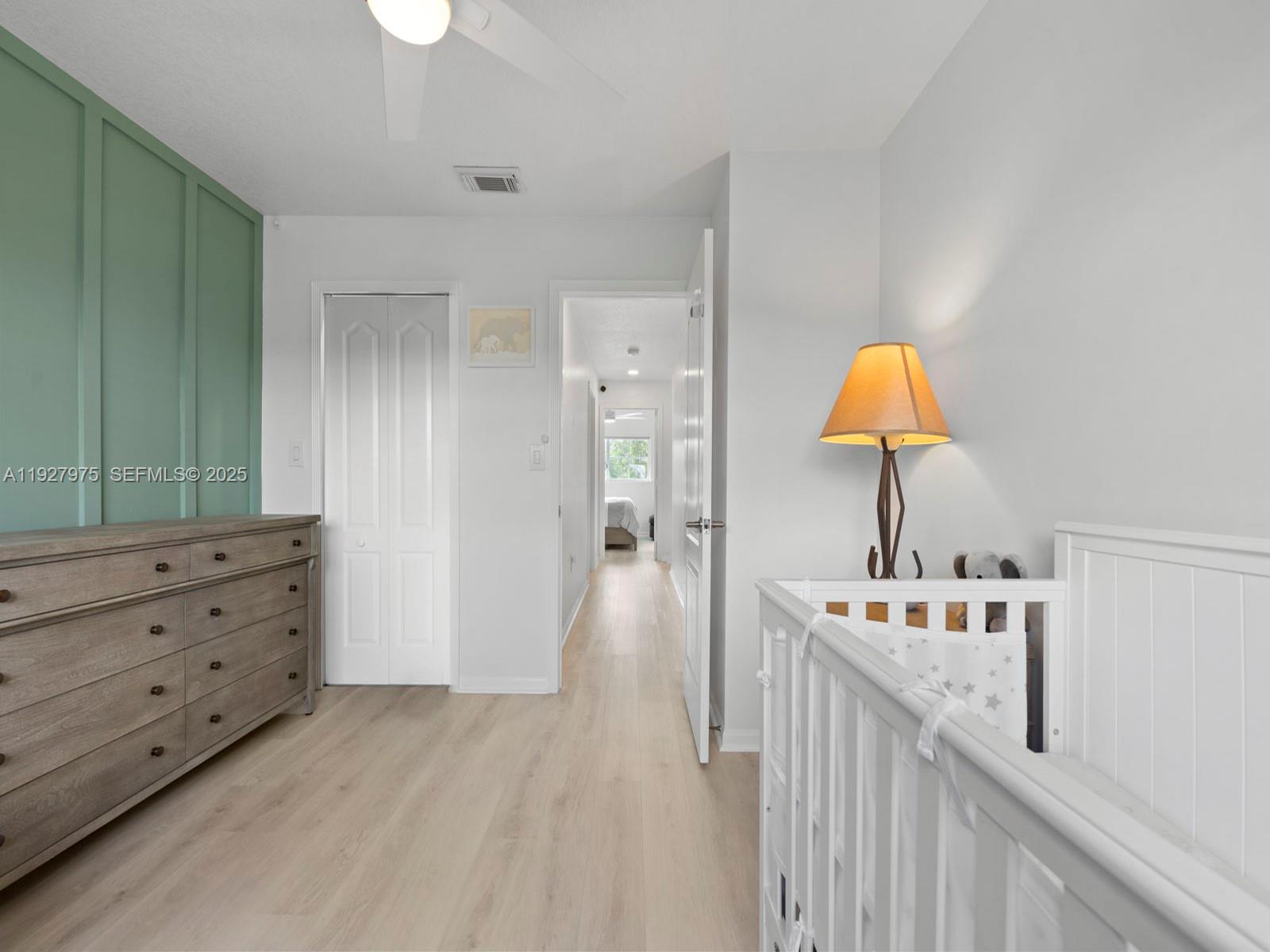 12881 Southwest 49th Court, Unit 12881 Miramar, FL 33027 - Photo 29 of 47 a hallway with cabinets and wooden floor