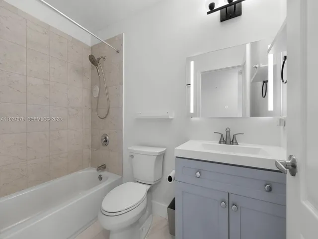 a bathroom with a sink toilet a shower and a mirror