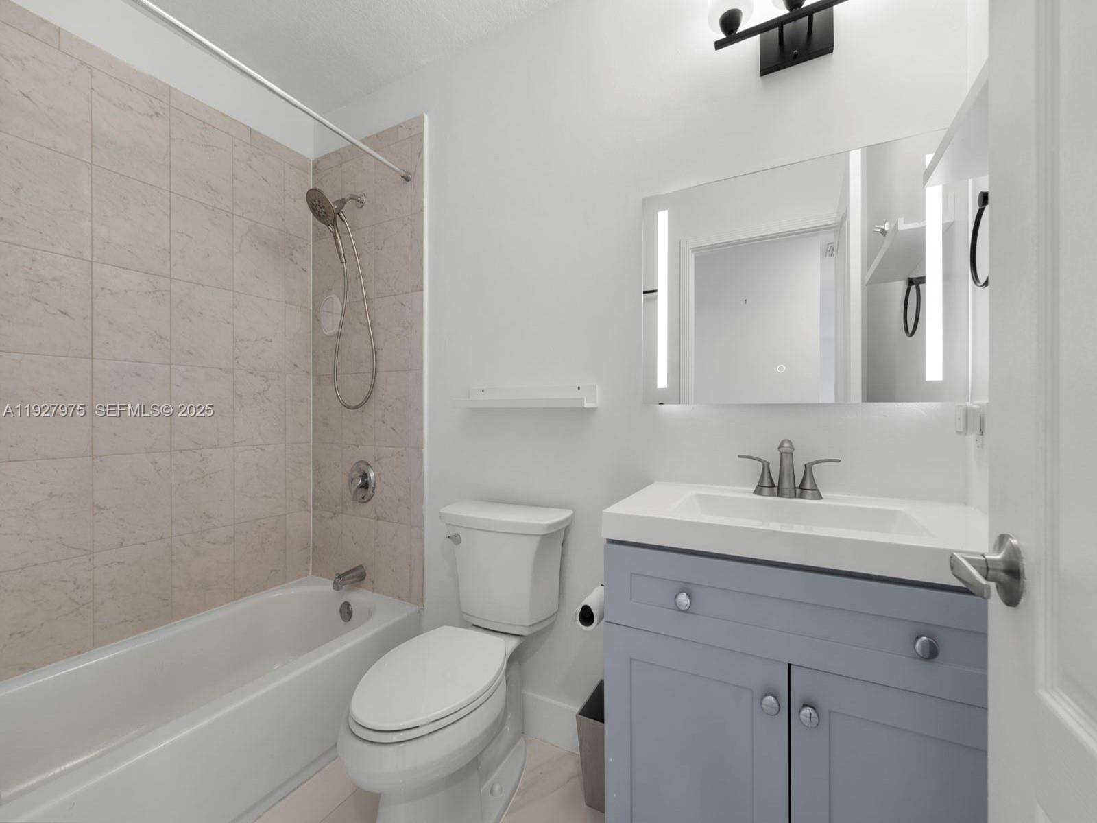 12881 Southwest 49th Court, Unit 12881 Miramar, FL 33027 - Photo 30 of 47 a bathroom with a sink toilet a shower and a mirror