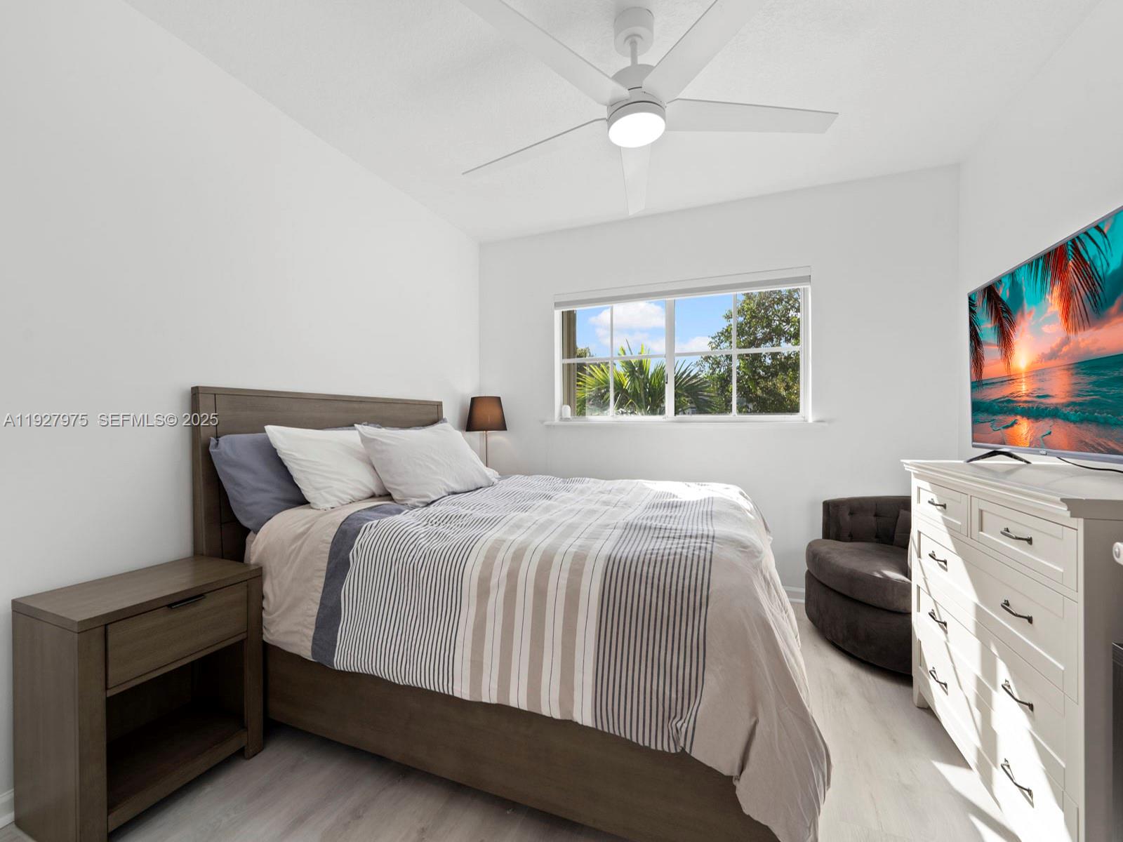 12881 Southwest 49th Court, Unit 12881 Miramar, FL 33027 - Photo 31 of 47 a bedroom with a large bed and a tv