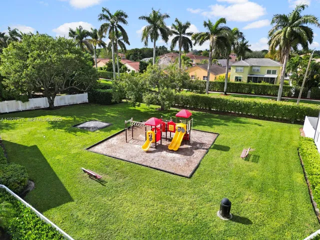 a view of swimming pool with a garden and plants