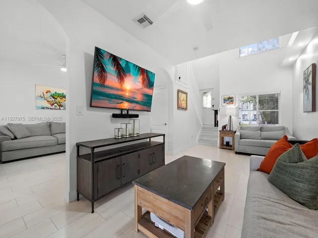 a living room with furniture and a flat screen tv