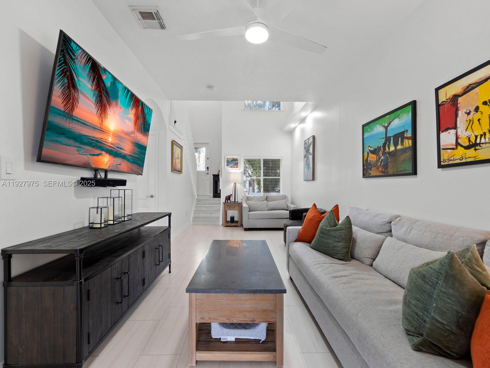 12881 Southwest 49th Court, Unit 12881 Miramar, FL 33027 - Photo 9 of 47 a living room with furniture and a flat screen tv