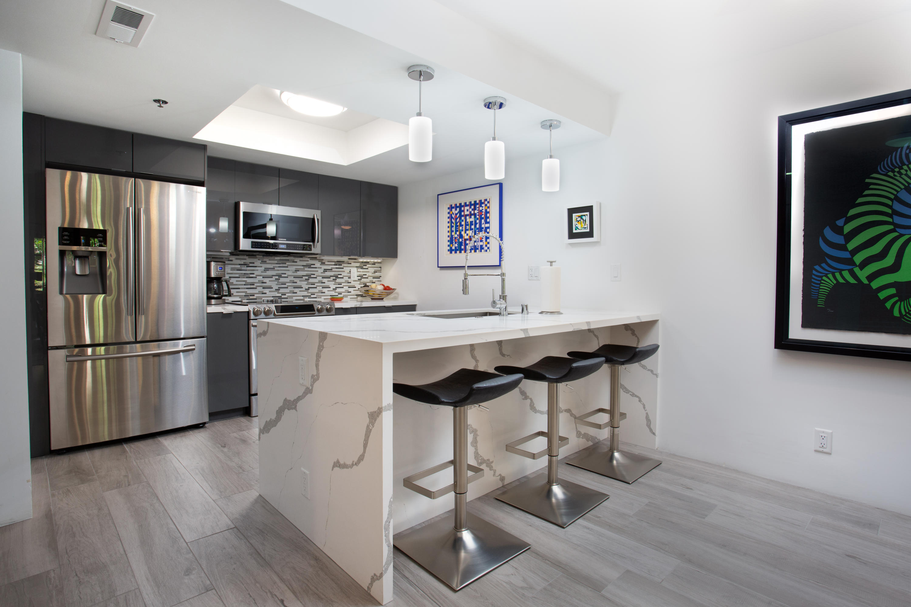 500 East Amado Road, Unit 111 Palm Springs, CA 92262 - Photo 15 of 48 a kitchen with stainless steel appliances a dining table chairs refrigerator and sink
