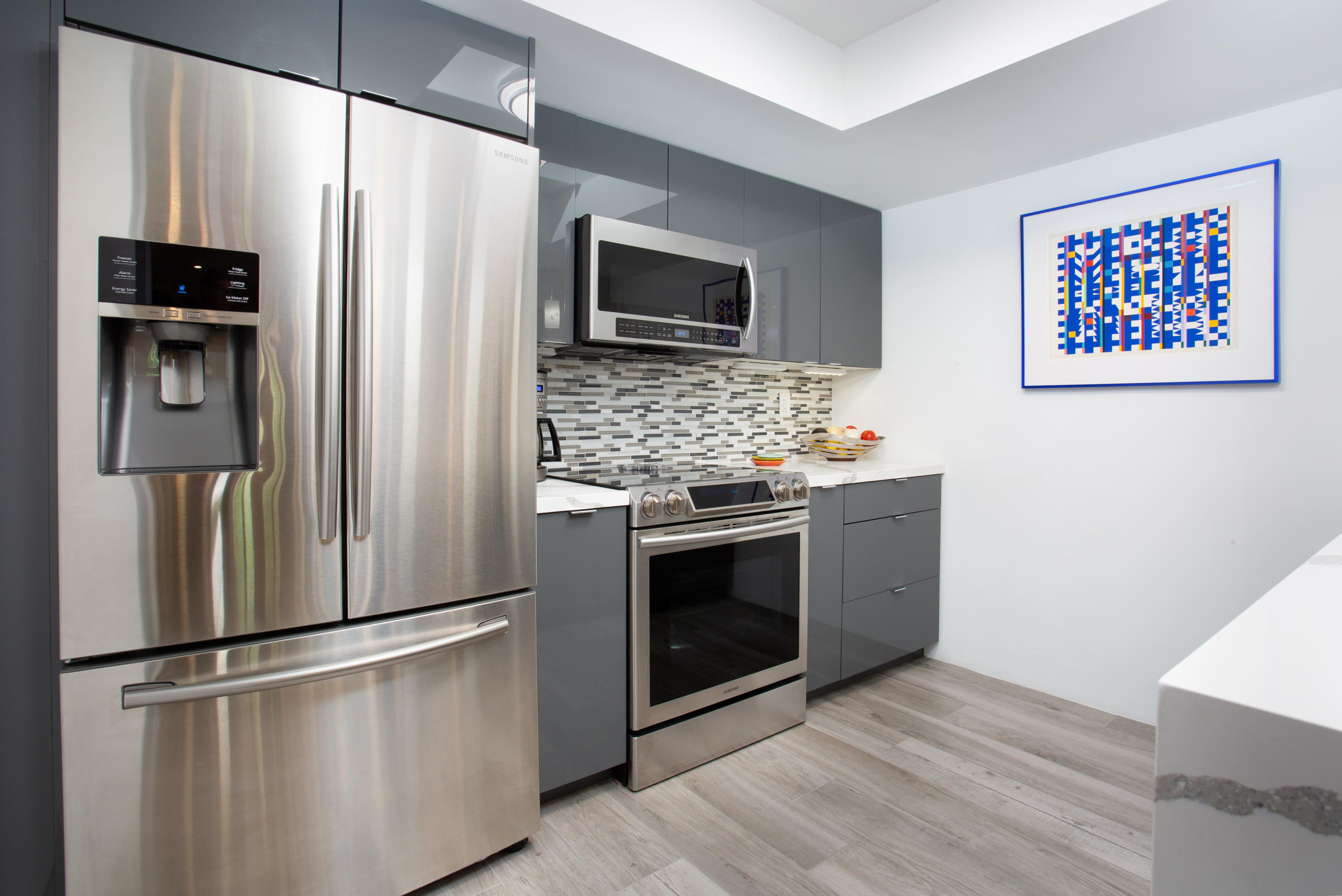 500 East Amado Road, Unit 111 Palm Springs, CA 92262 - Photo 16 of 48 a kitchen with stainless steel appliances a refrigerator stove and microwave