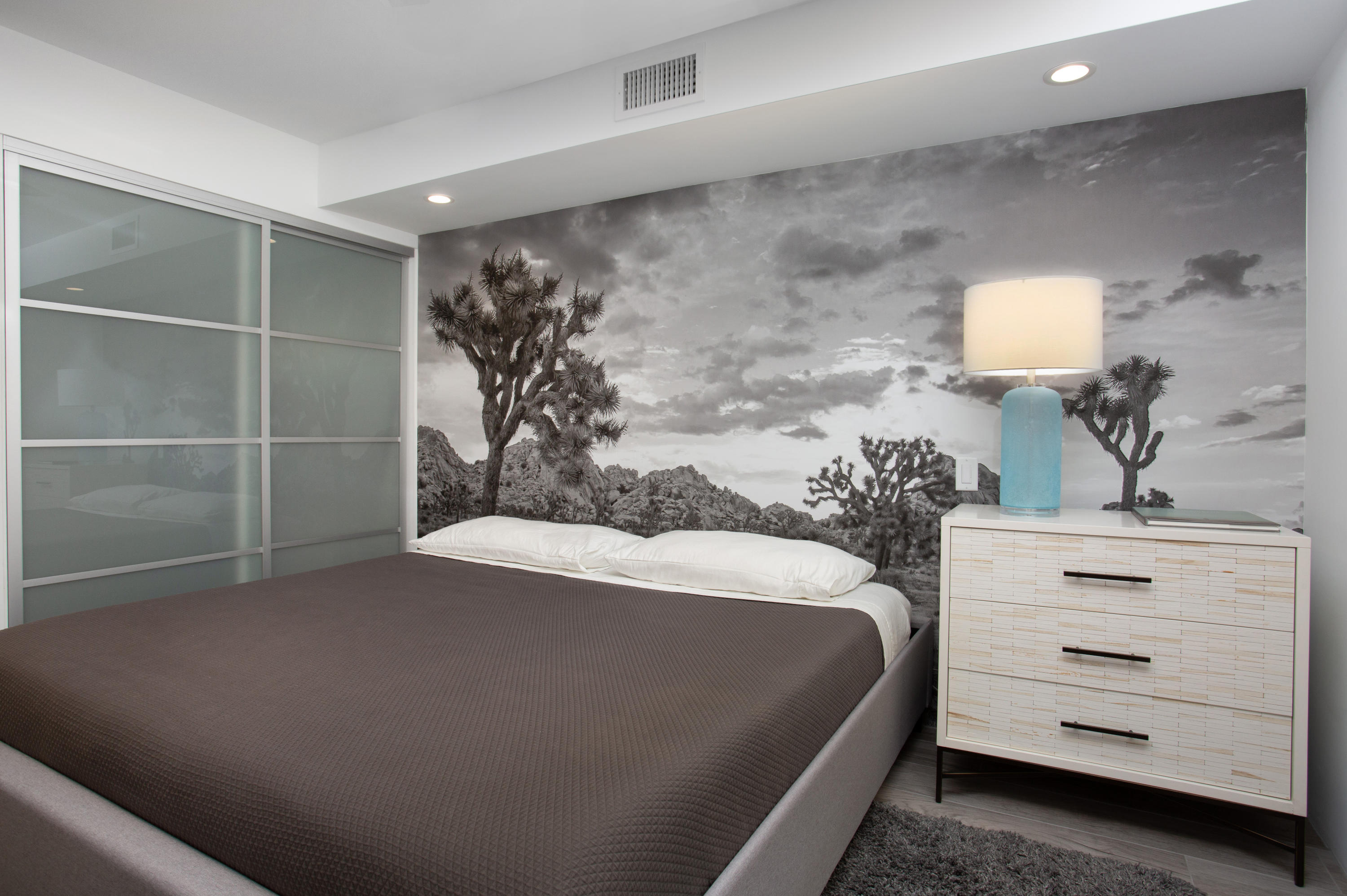 500 East Amado Road, Unit 111 Palm Springs, CA 92262 - Photo 33 of 48 a bedroom with a bed and a dresser