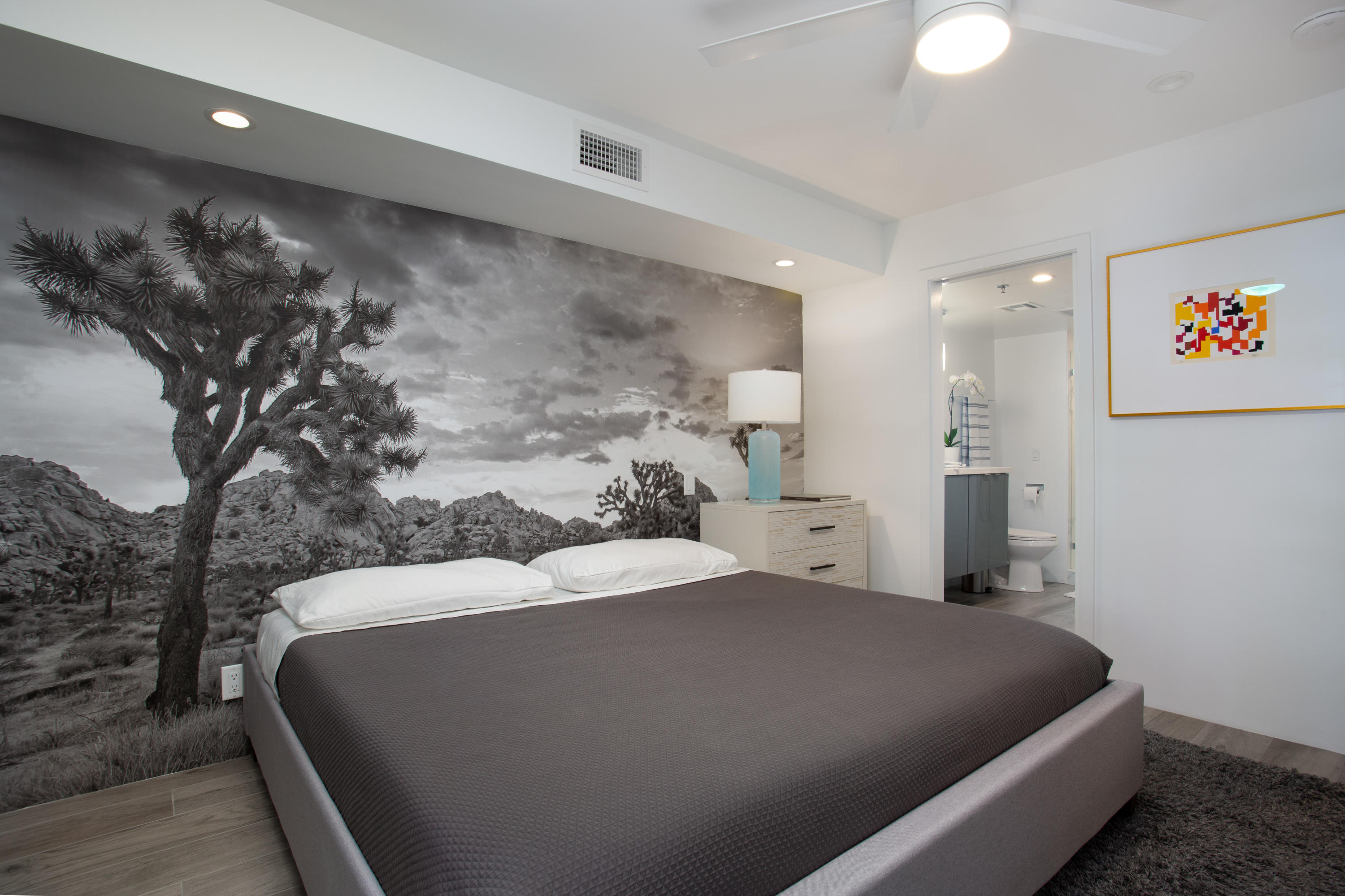 500 East Amado Road, Unit 111 Palm Springs, CA 92262 - Photo 36 of 48 a bedroom with a large bed and a chandelier