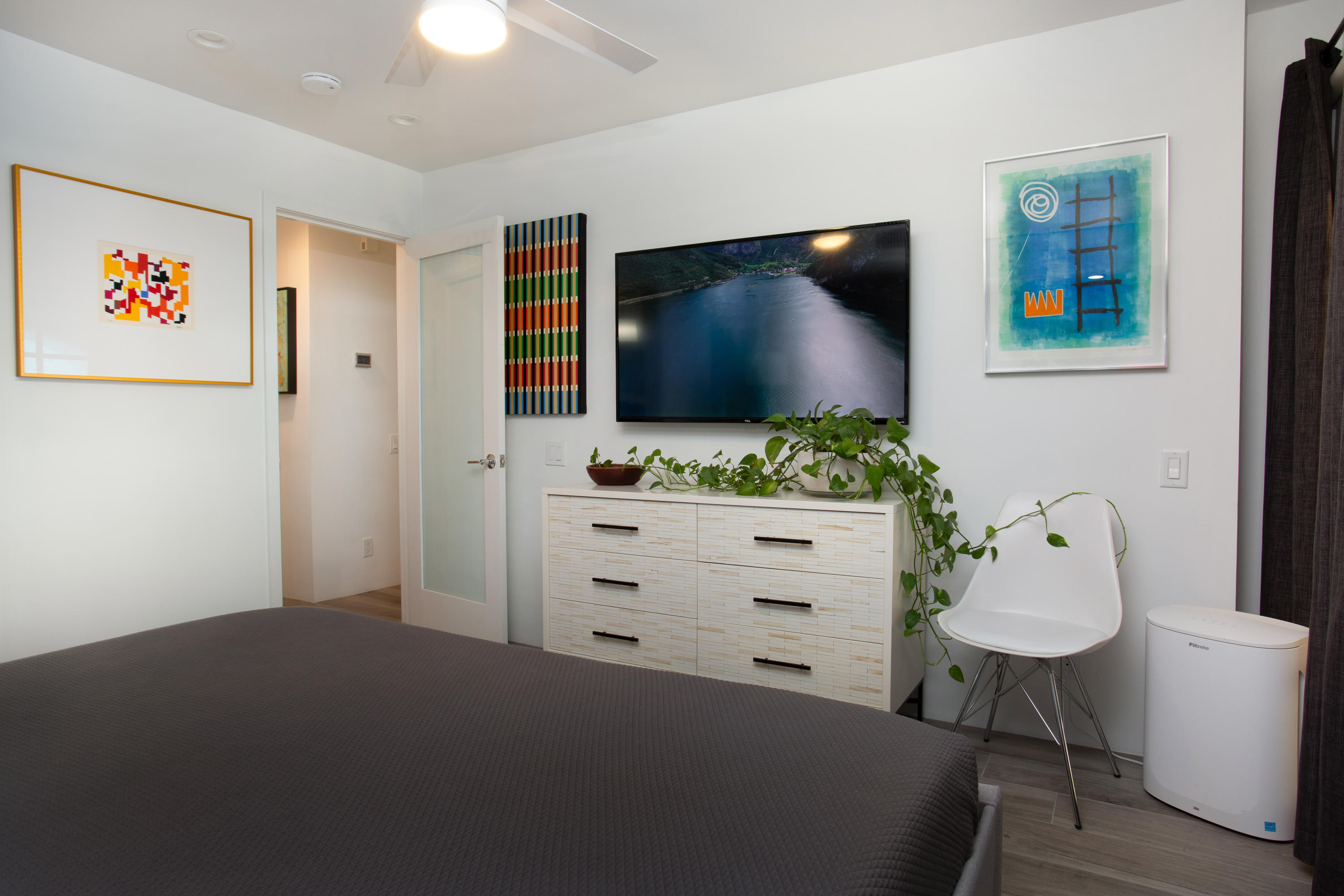500 East Amado Road, Unit 111 Palm Springs, CA 92262 - Photo 41 of 48 a bedroom with a bed and a flat screen tv