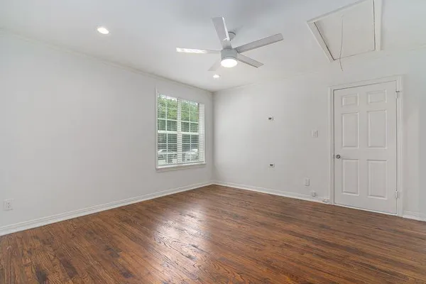 wooden floor in an empty room with a window