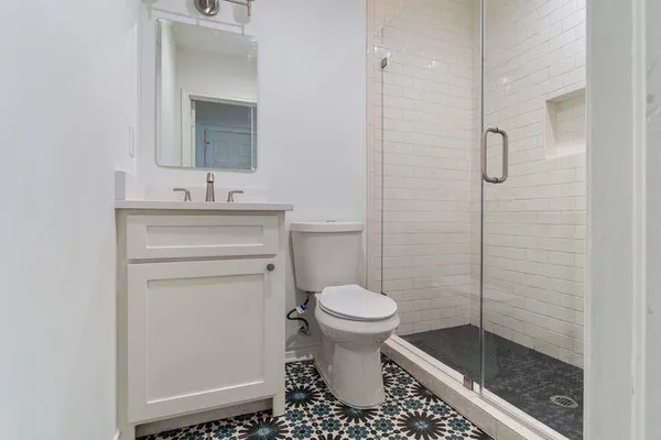 a bathroom with a toilet sink and shower