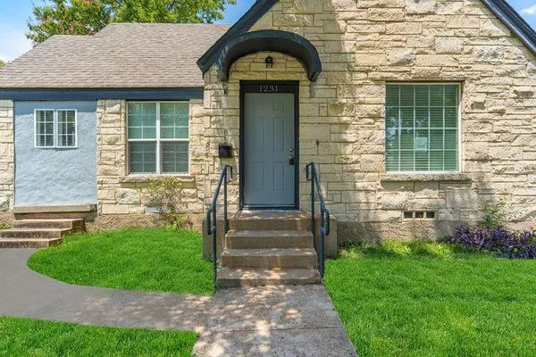 a front view of a house with a garden