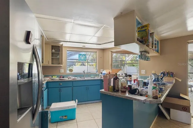 a kitchen with a sink cabinets and window