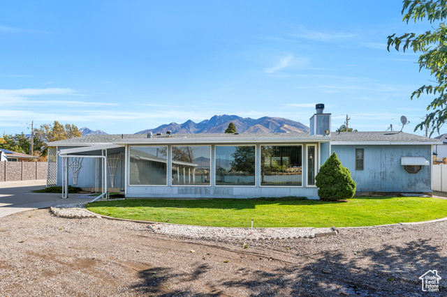 12958 South 300 East Draper, UT 84020 - Photo 37 of 38 Rear view of property featuring a mountain view, a chimney, a sunroom, and a shingled roof