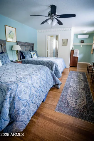 a bedroom with a bed and painting on the wall