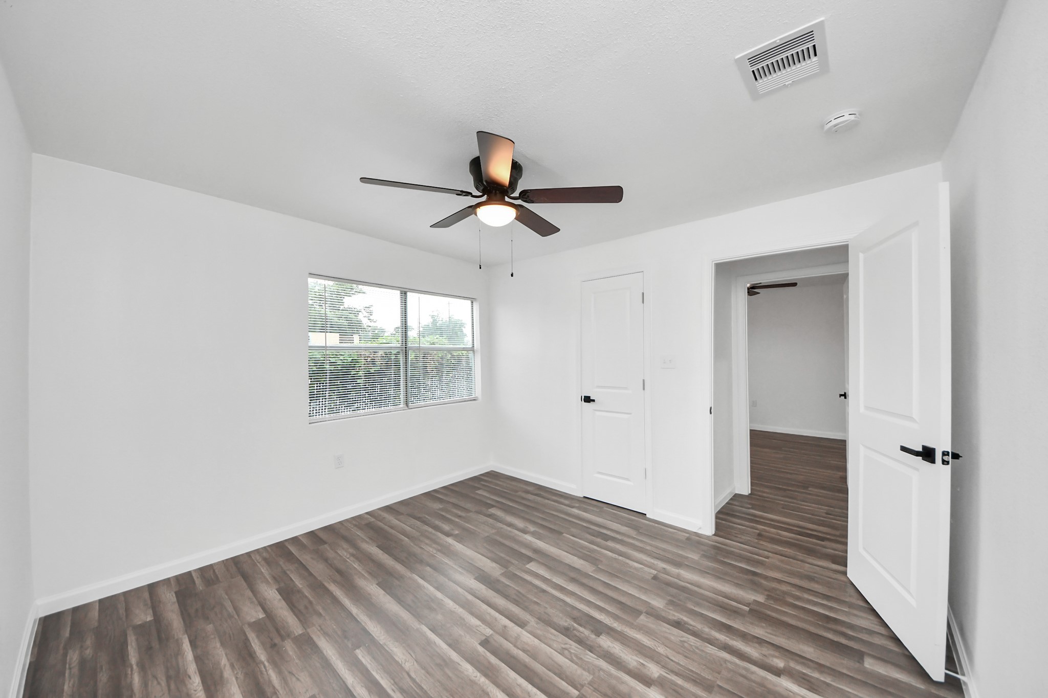 207 East Defee Avenue Baytown, TX 77520 - Photo 27 of 36 wooden floor in an empty room with a window