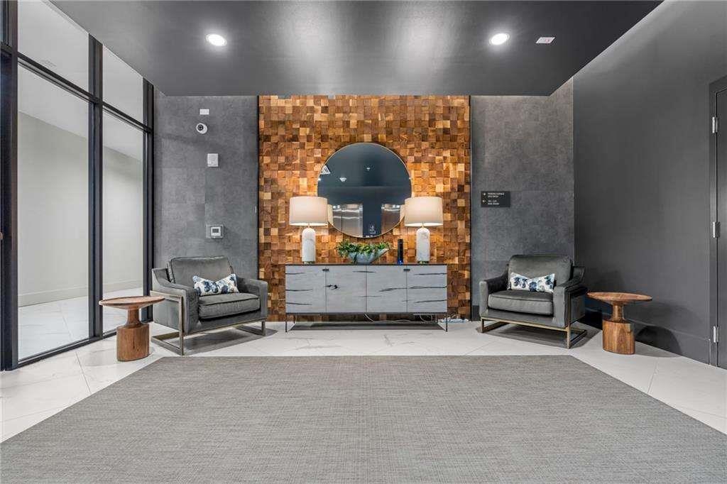 775 Juniper Street Northeast, Unit 111 Atlanta, GA 30308 - Photo 25 of 56 a living room with furniture and a mirror