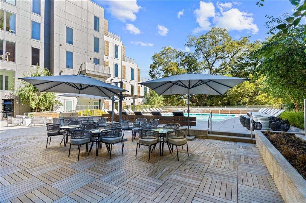 775 Juniper Street Northeast, Unit 111 Atlanta, GA 30308 - Photo 32 of 56 a view of a dinning table and chairs in patio area of the house
