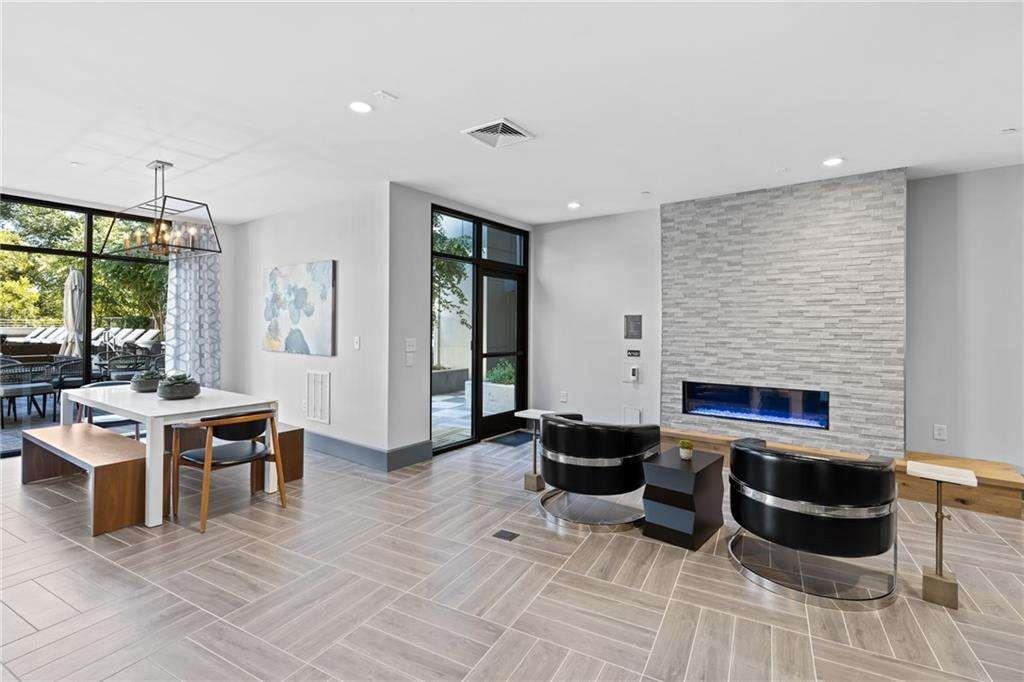 775 Juniper Street Northeast, Unit 111 Atlanta, GA 30308 - Photo 36 of 56 a living room with furniture a fireplace and a table