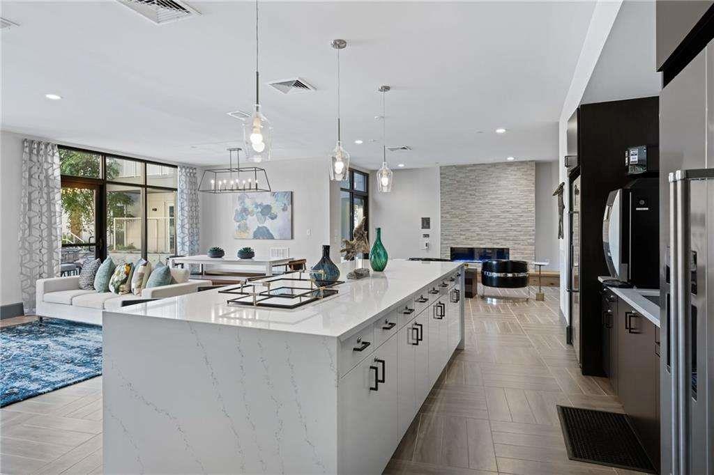 775 Juniper Street Northeast, Unit 111 Atlanta, GA 30308 - Photo 40 of 56 a kitchen with stainless steel appliances a sink stove and refrigerator