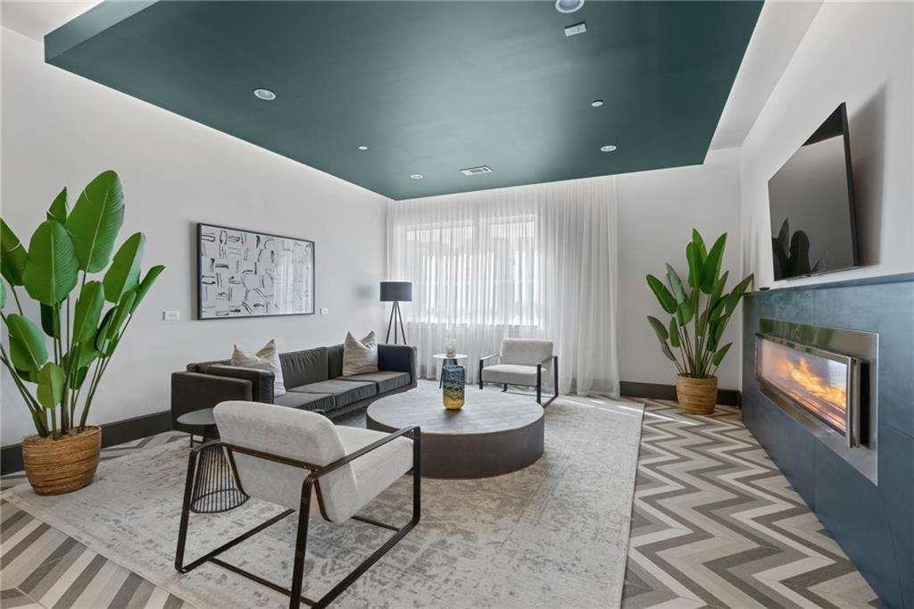 775 Juniper Street Northeast, Unit 111 Atlanta, GA 30308 - Photo 52 of 56 a living room with furniture a potted plant and a fireplace