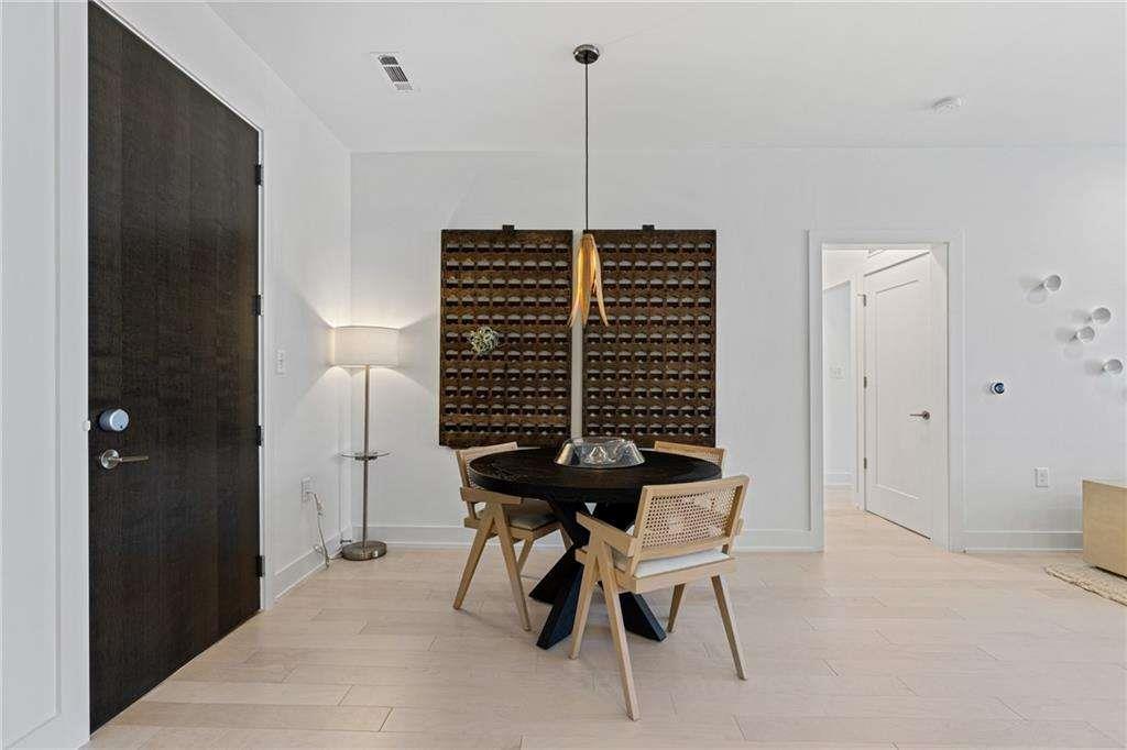 775 Juniper Street Northeast, Unit 111 Atlanta, GA 30308 - Photo 8 of 56 a view of a hallway with furniture and wooden floor