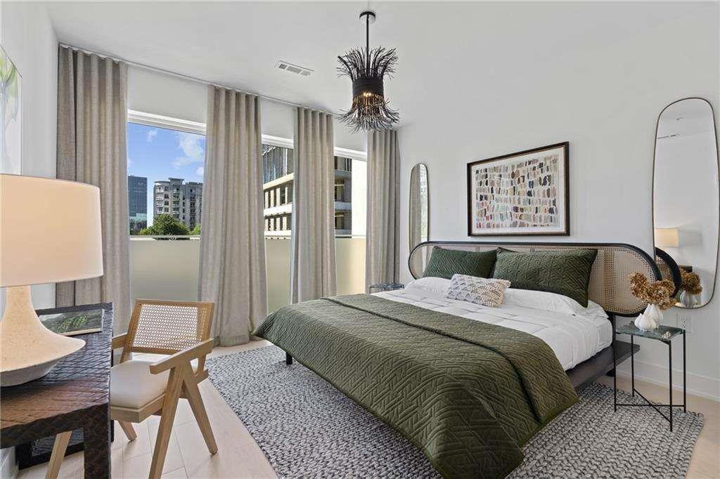 775 Juniper Street Northeast, Unit 111 Atlanta, GA 30308 - Photo 9 of 56 a spacious bedroom with a bed dresser and a window