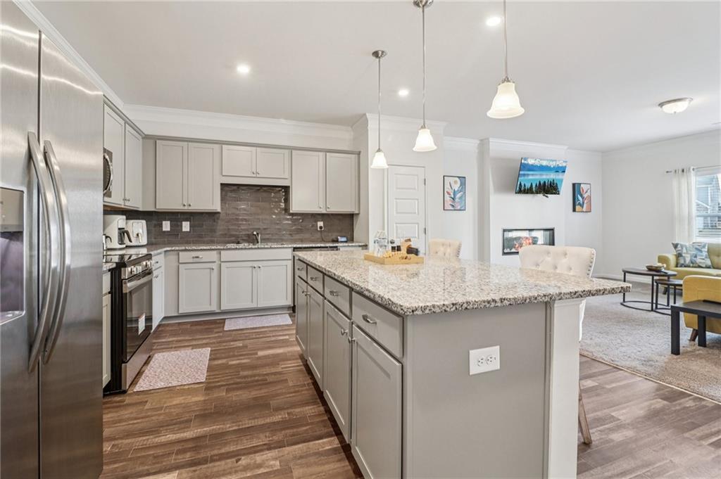 3625 Fairhaven Drive Powder Springs, GA 30127 - Photo 6 of 20 a kitchen with granite countertop a sink a counter top space stainless steel appliances and cabinets