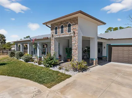a front view of a house with yard and green space