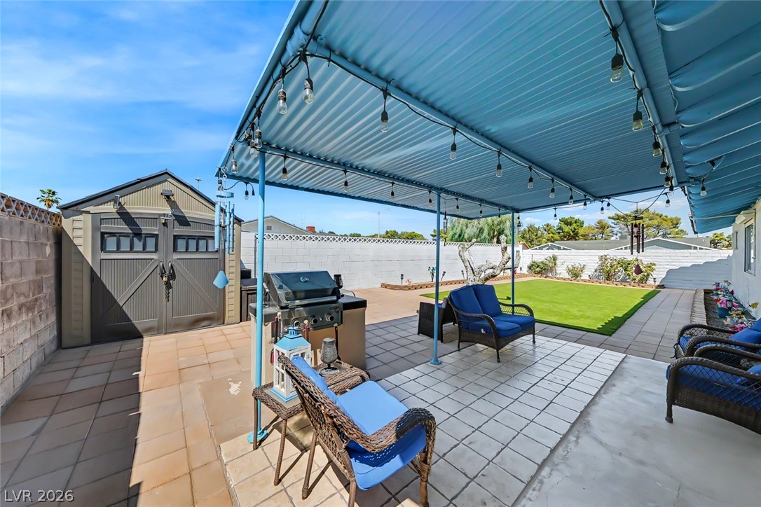 3107 Trueno Road Henderson, NV 89014 - Photo 33 of 37 An inviting backyard oasis offers a covered patio ideal for outdoor gatherings and relaxation.