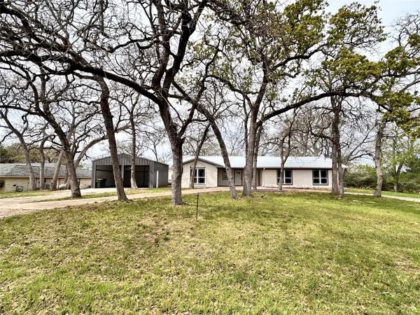 a house that has a tree in front of it