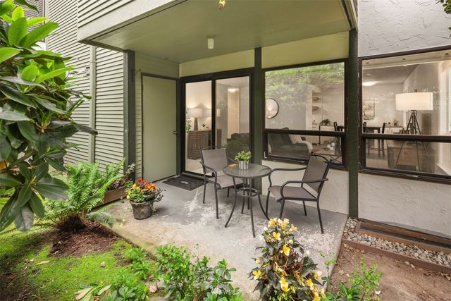 a view of a patio with table and chairs and potted plants