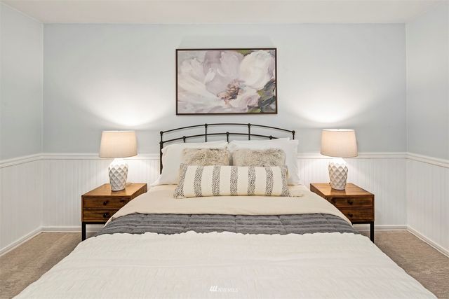 a bedroom with a bed and lamp