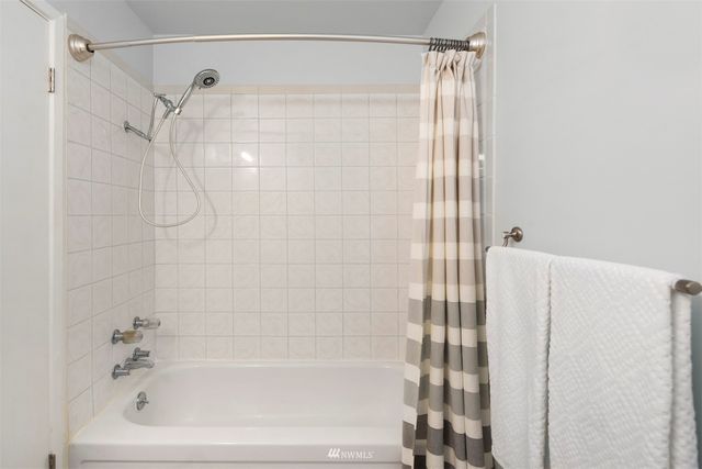 a bathroom with a shower and a bath tub