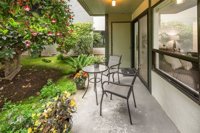 a view of a chairs and table in the balcony