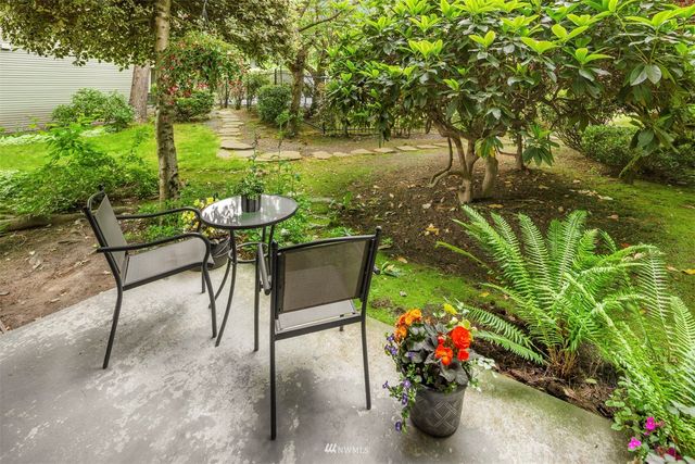 a view of a chairs and table in the garden